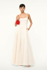Ivory maxi dress with spaghetti straps, scoop neckline, and full pleated skirt