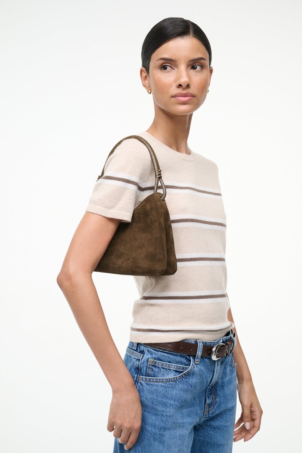 Truffle suede shoulder bag with short top handles, carried at hip