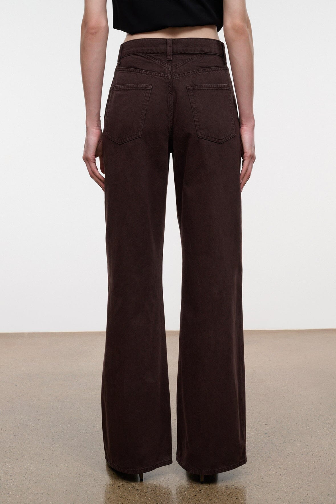 Dark brown wide-leg DEAN jeans with belt loops, front pockets, and flared hem
