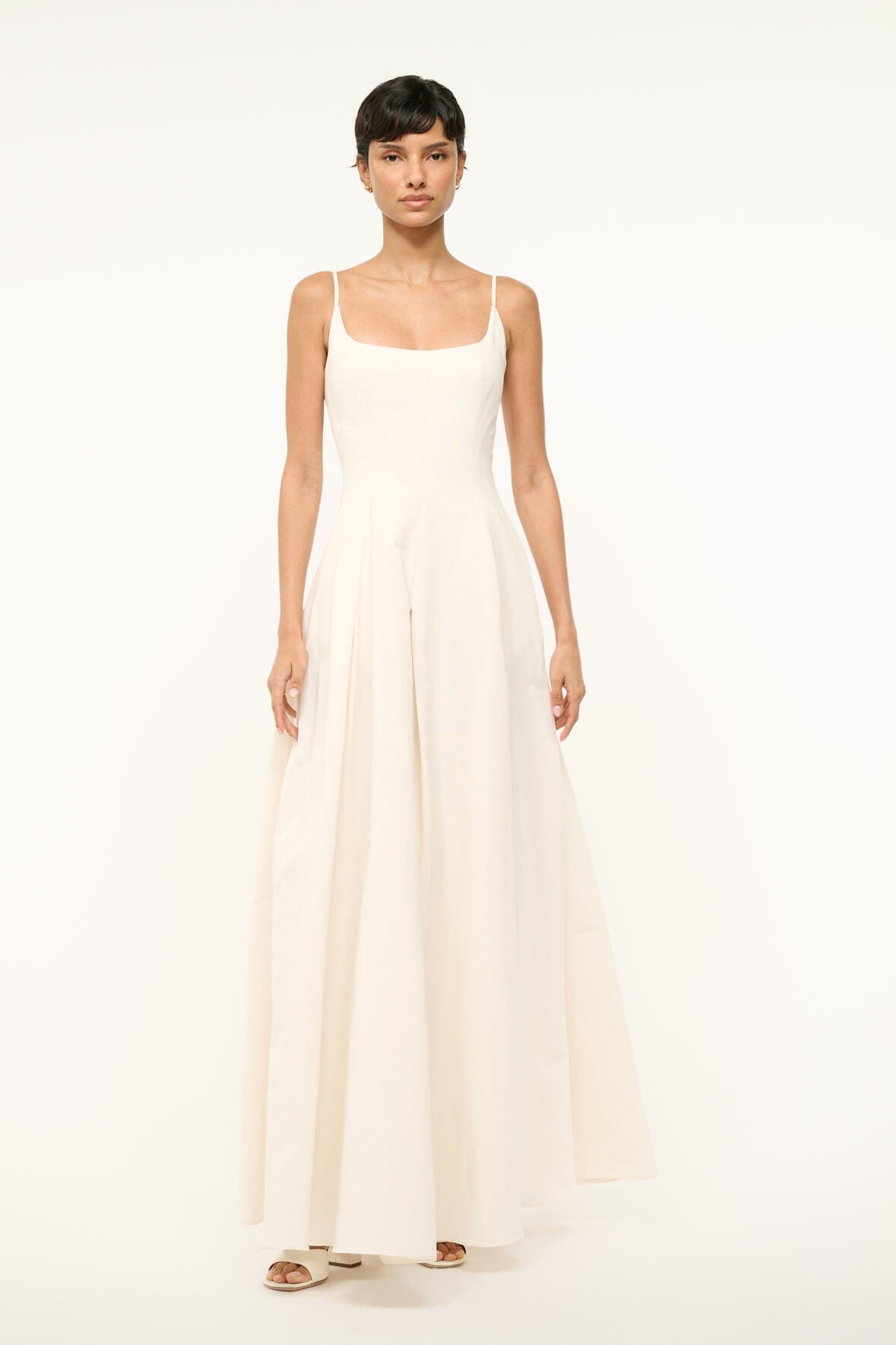 Ivory sleeveless maxi dress with gathered waist and long pleated skirt