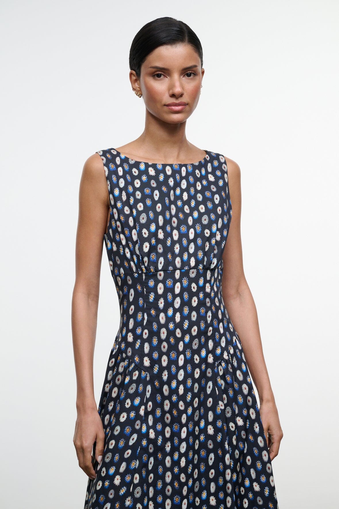 Sleeveless navy midi dress with abstract yellow-dot print, round neckline and fitted bodice