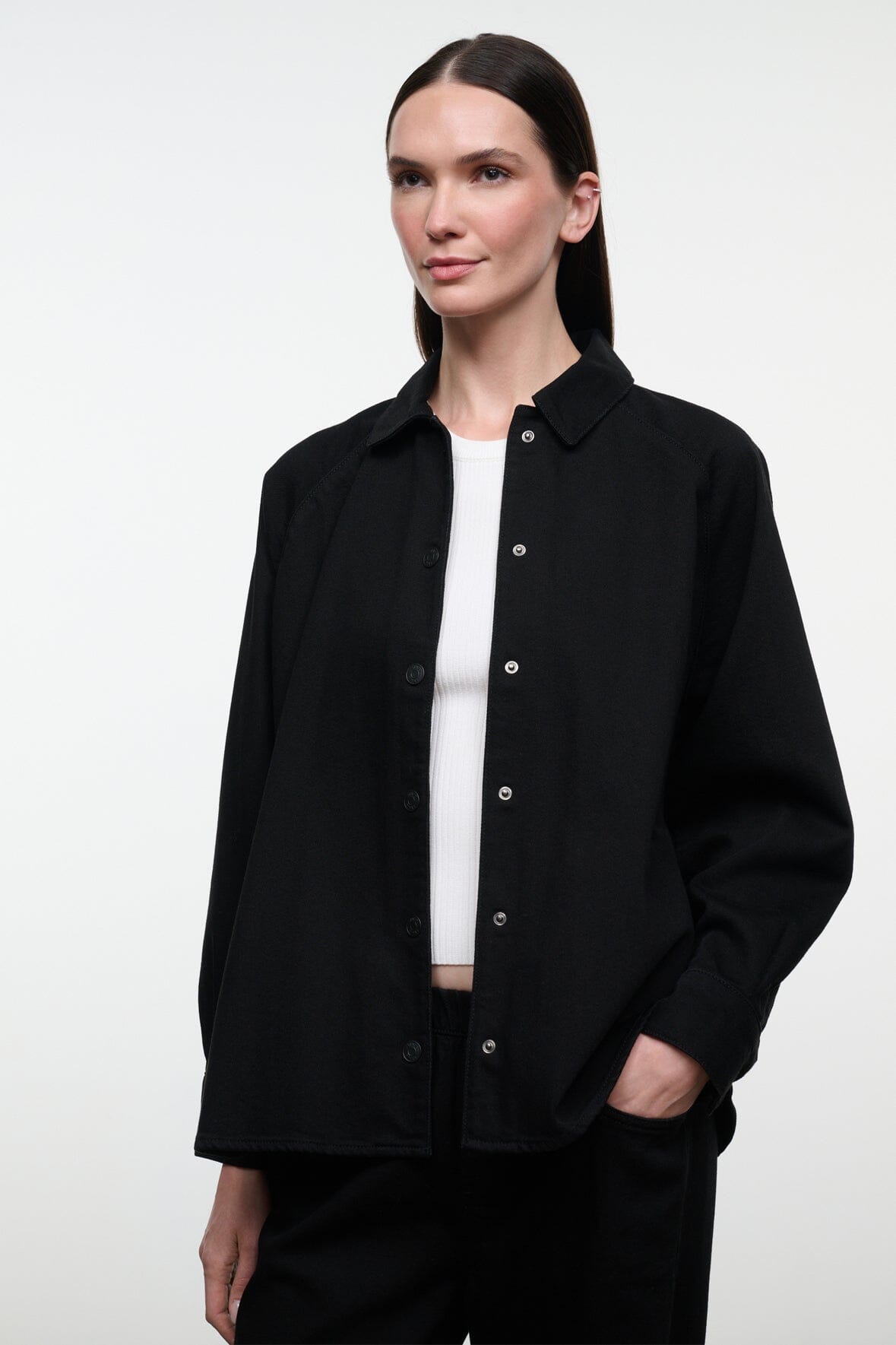 Black shirt jacket with stand collar, button front, and long sleeves; front view.