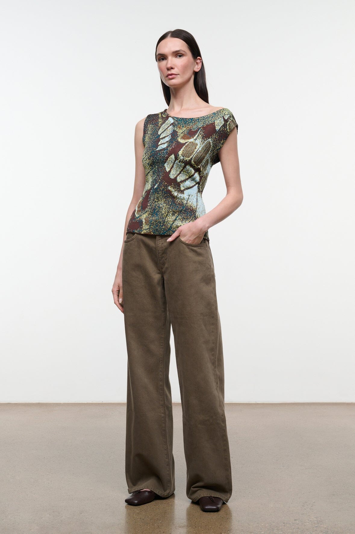 Side view of sleeveless printed top with green-gold butterfly motif and scoop neckline