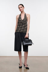 Black mini carryall handbag with top handles and circular textured front panel