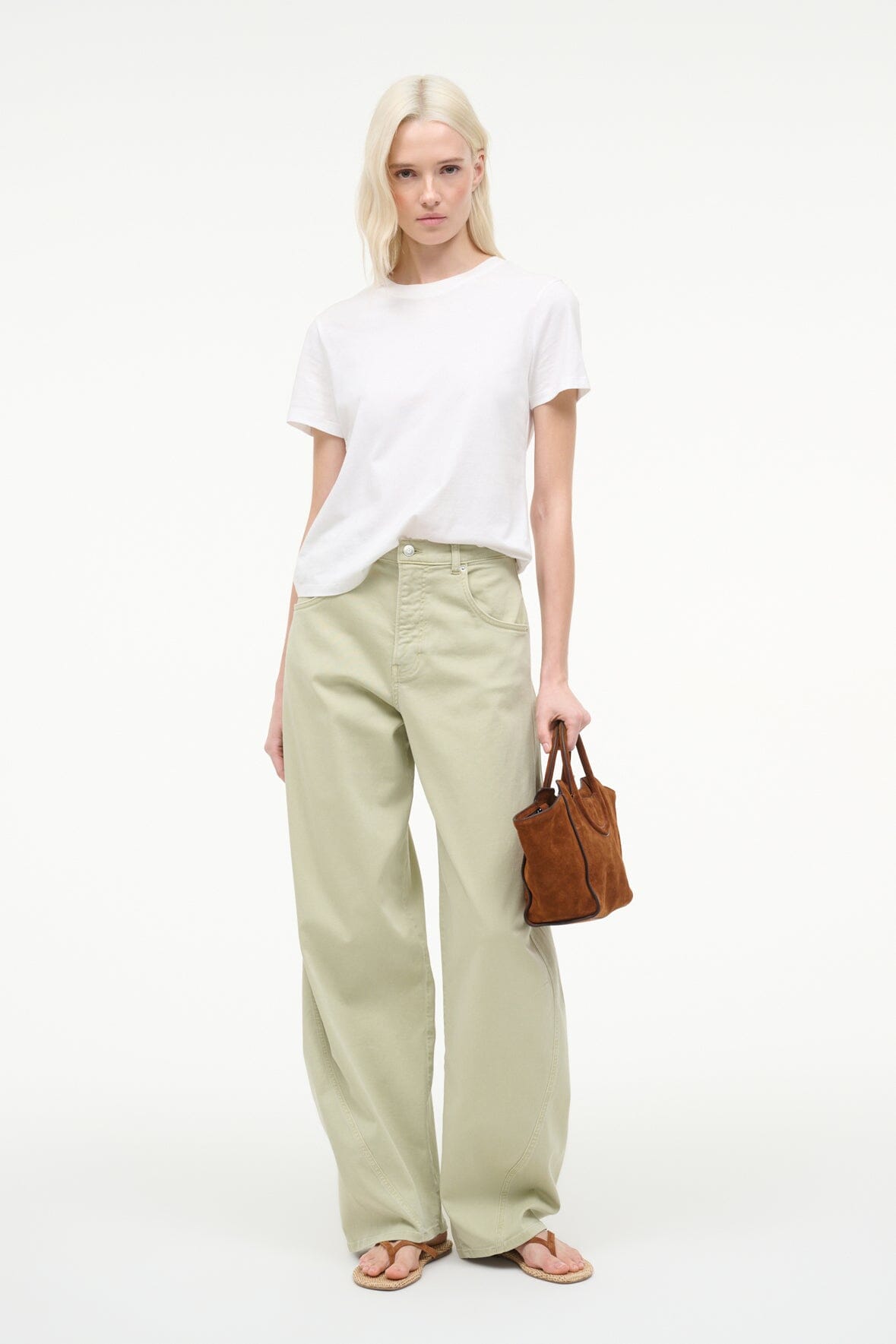 Tabac suede mini tote bag on model, compact shape with open top