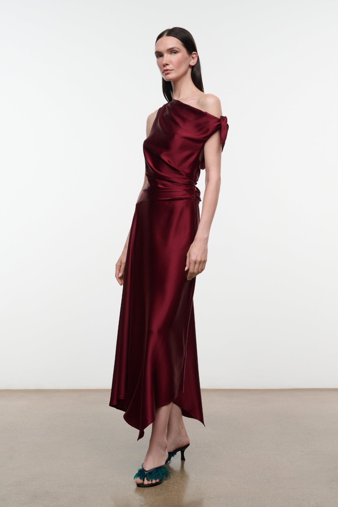 Deep burgundy silk midi dress with draped neckline and asymmetrical tie detail