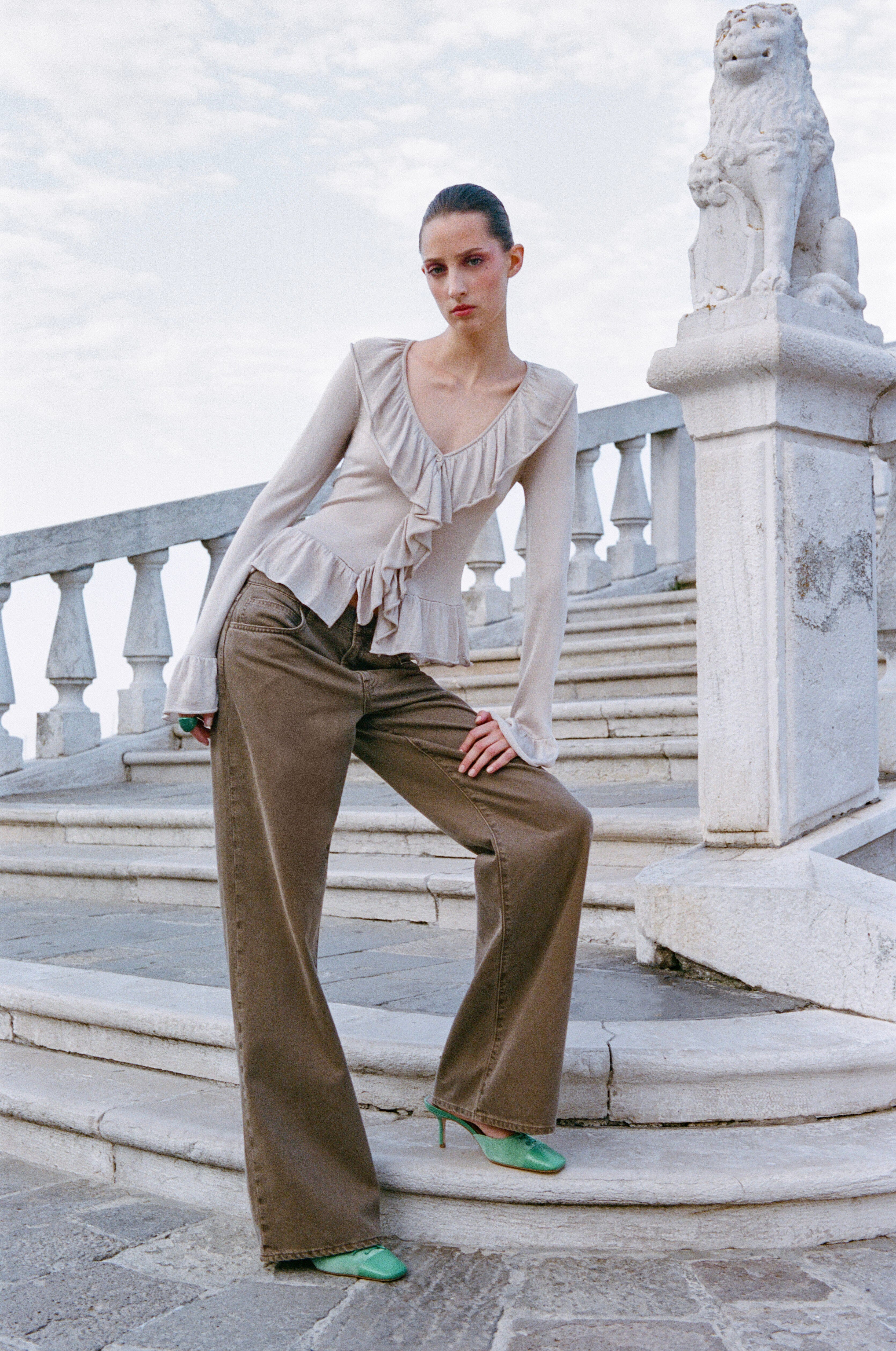 Champagne ruffle blouse with V-neck, long sleeves, and tiered front detailing