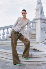 Champagne ruffle blouse with V-neck, long sleeves, and tiered front detailing
