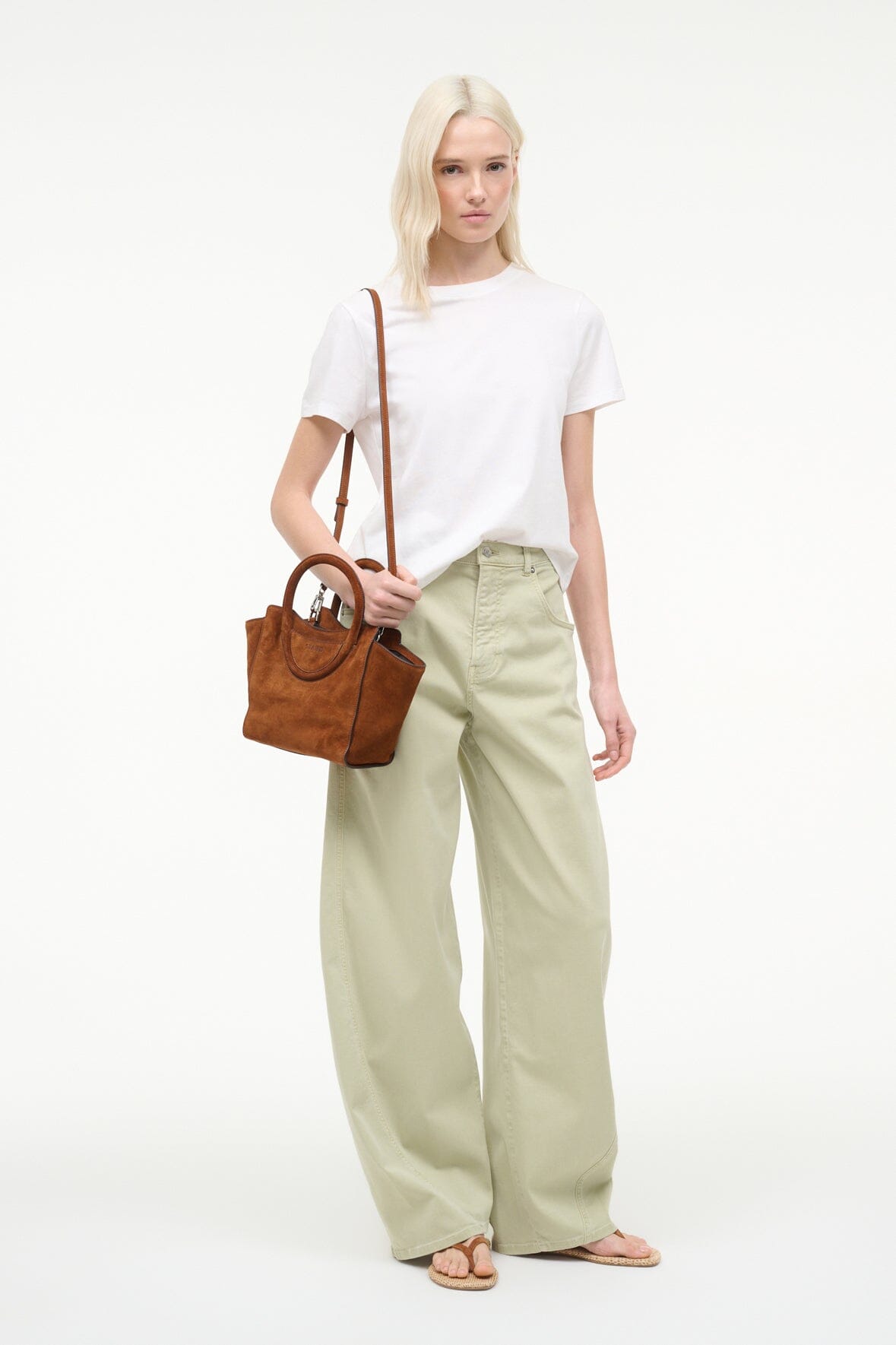 Tabac suede mini tote bag carried on model, with top handles and open top