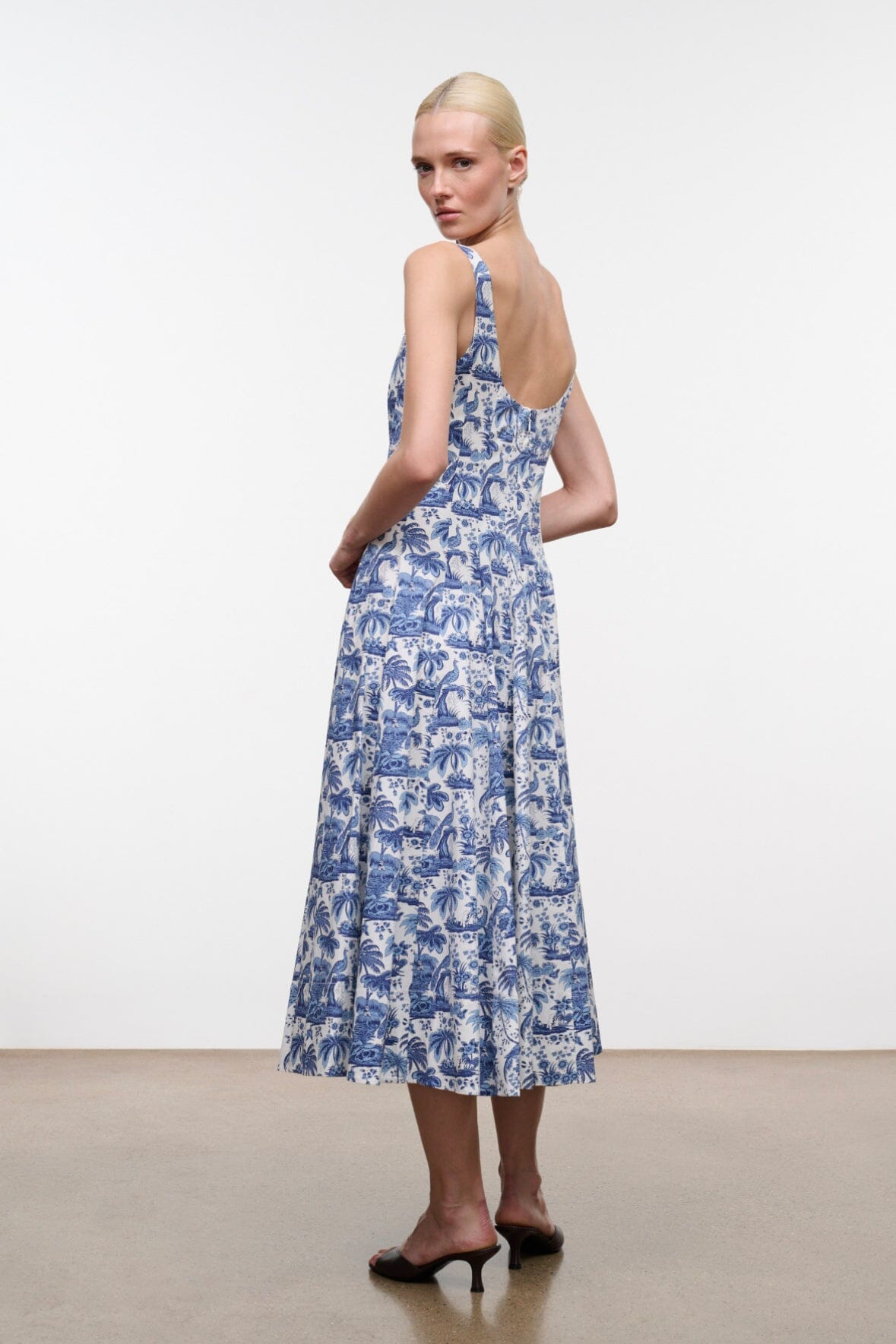 Blue toile print midi dress with thin straps and side view silhouette