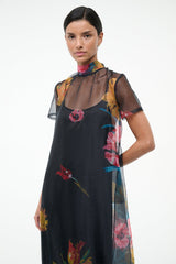 Black floral sheer dress with high neckline, short sleeves, and tiered maxi skirt