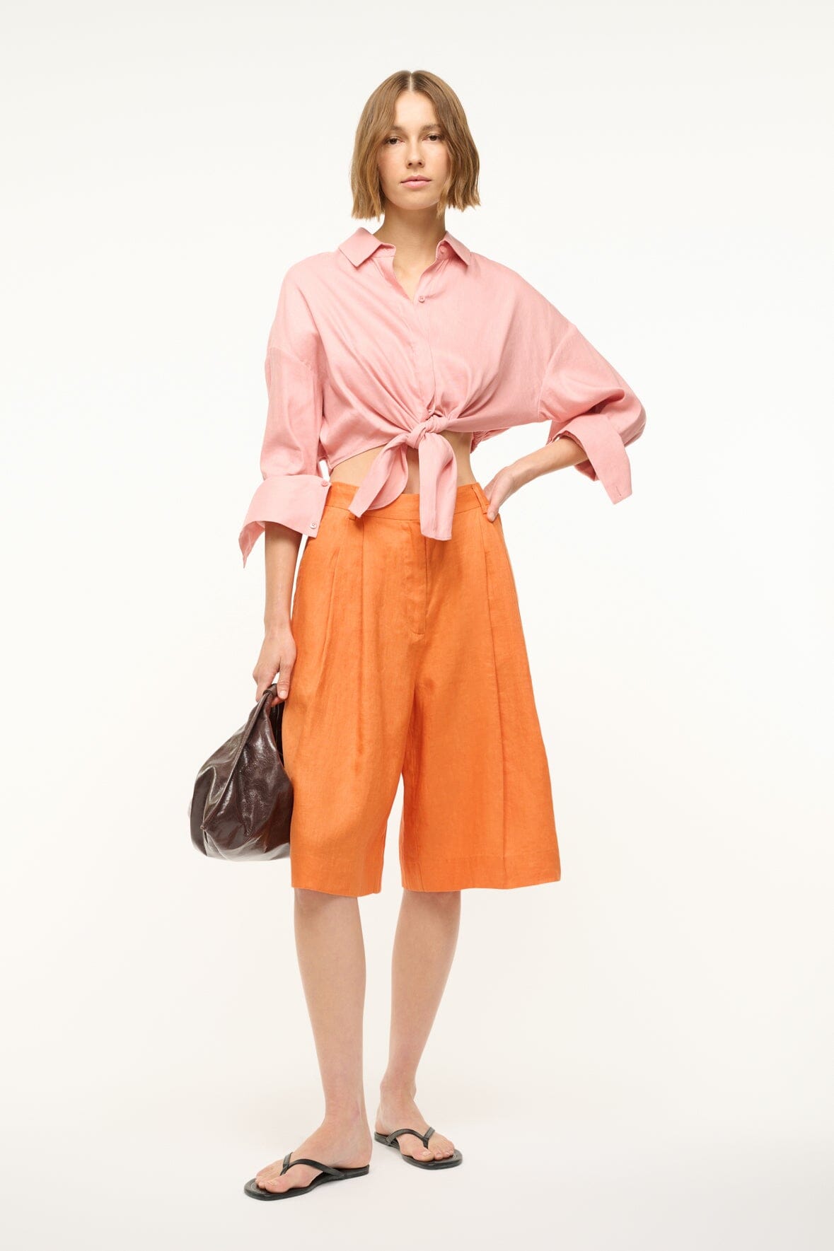 Faded blush linen button-up top with pointed collar and tied waist front