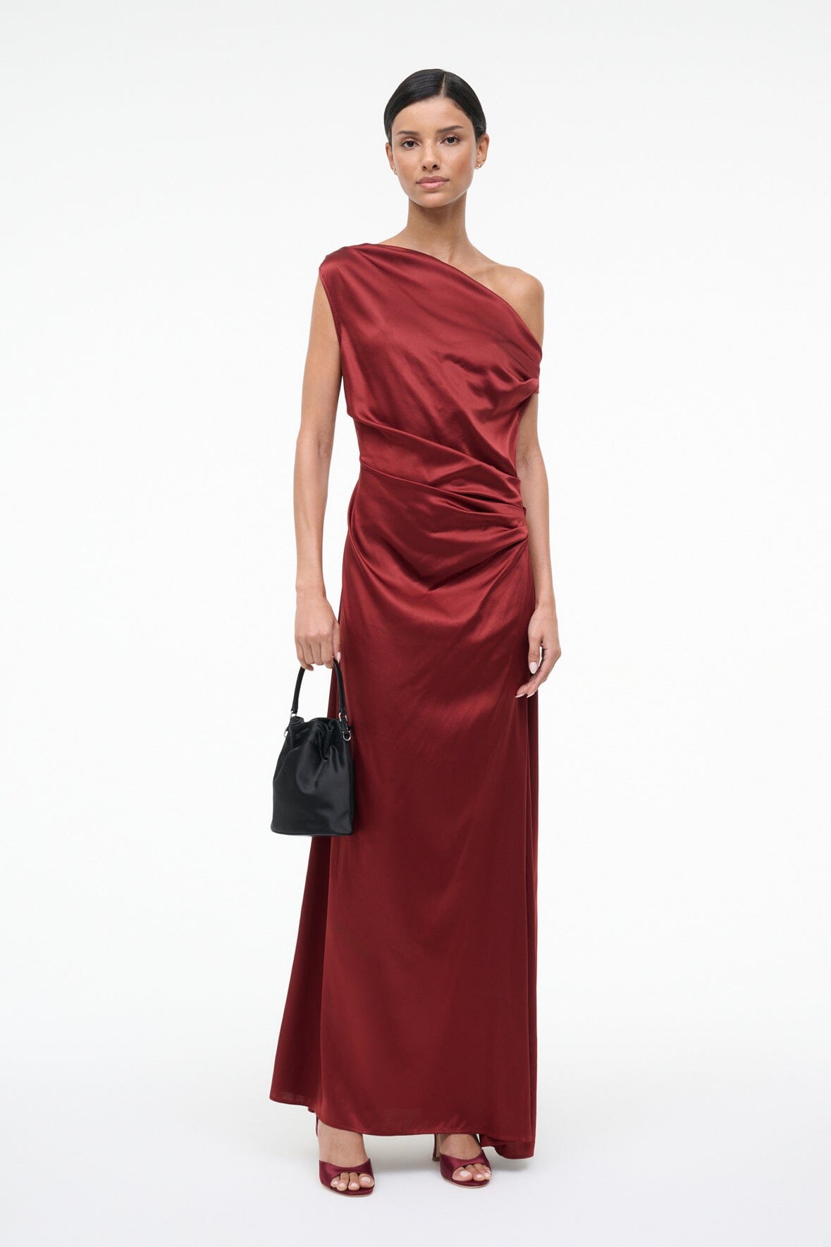 Burgundy silk maxi dress with one-shoulder drape, ruched waist and flowing ankle skirt