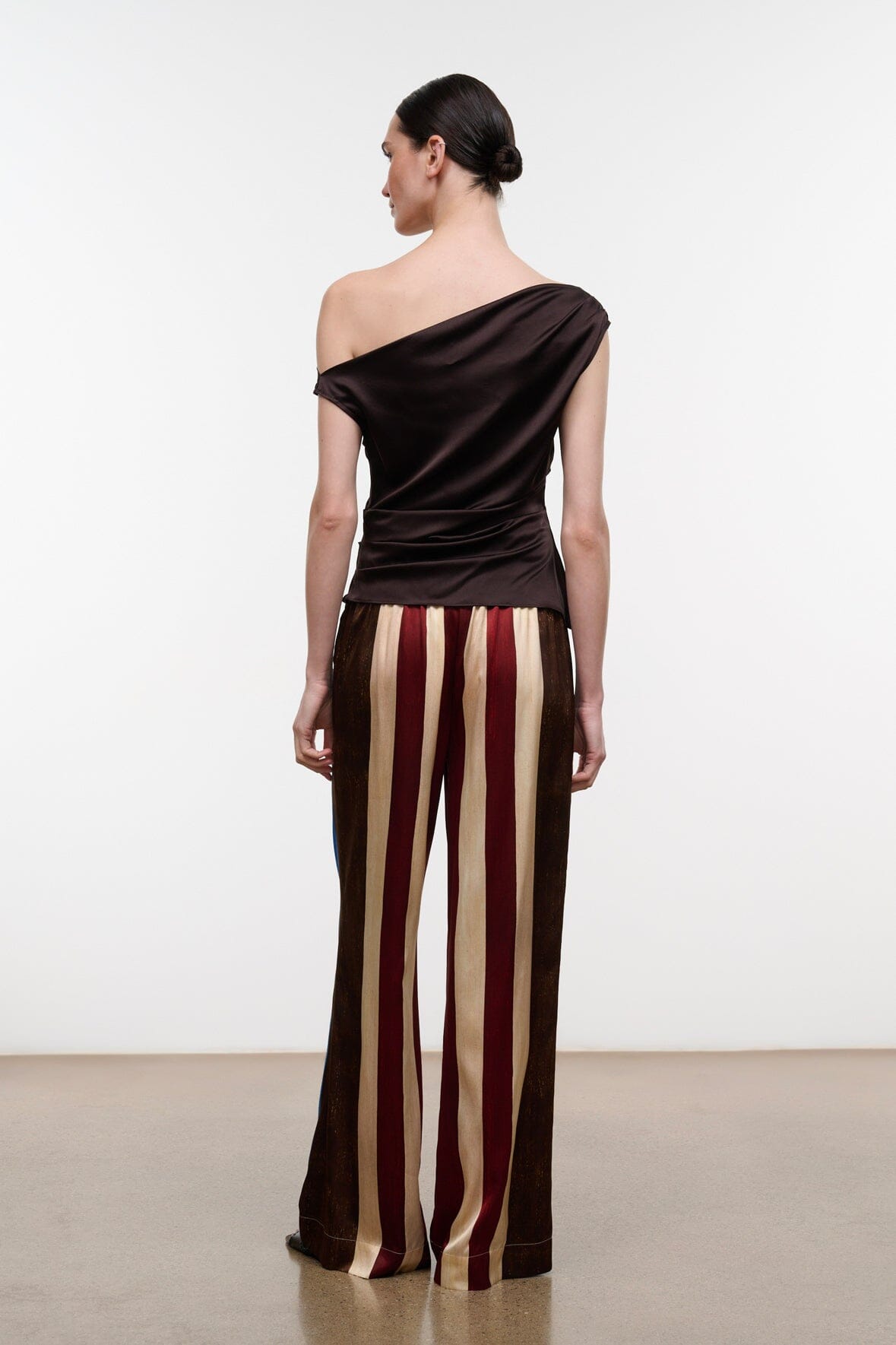 Silk wide-leg pants with vertical stripe pattern in dark brown, burgundy, and cream