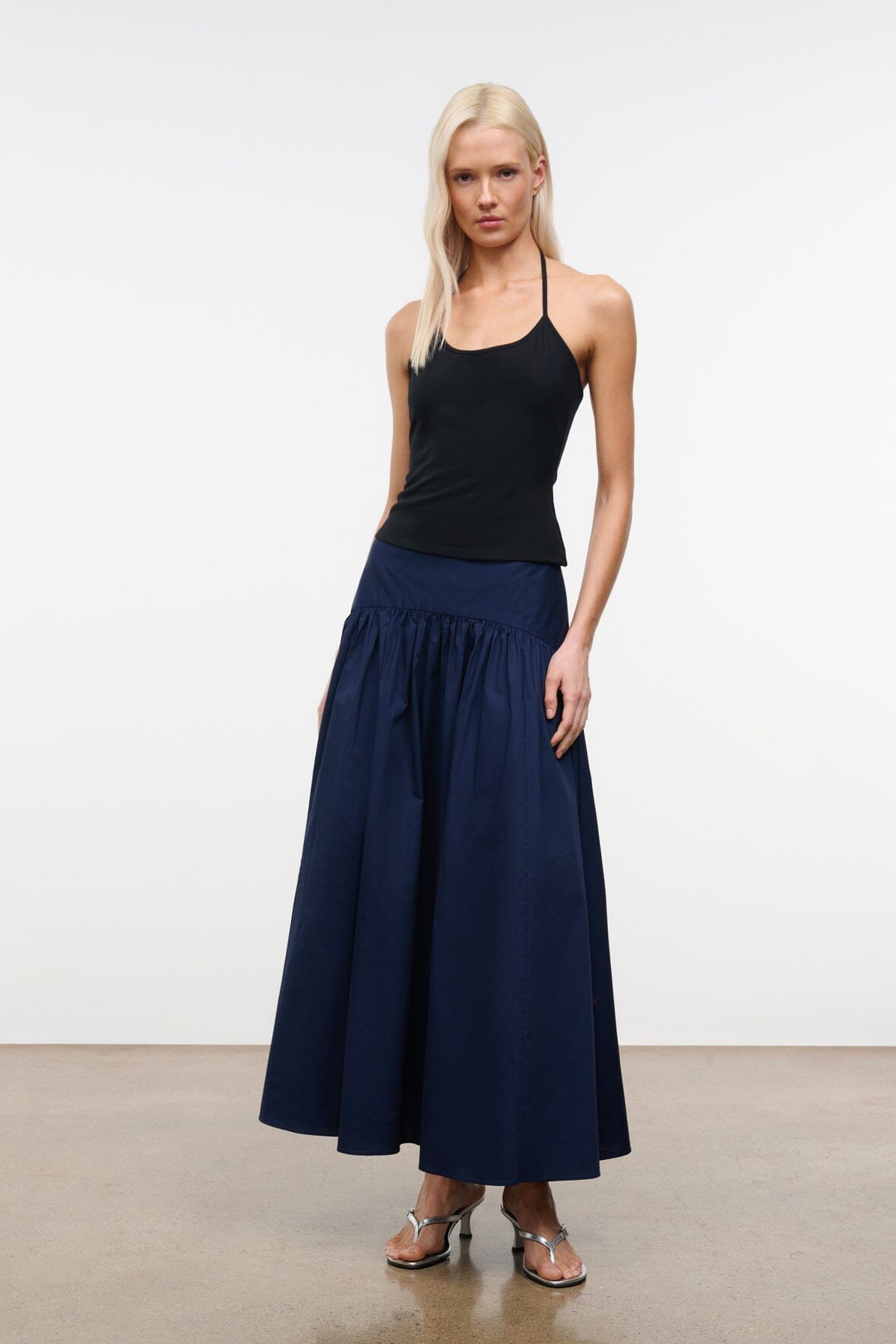 Navy gathered midi skirt with elastic waistband and full pleated tiers