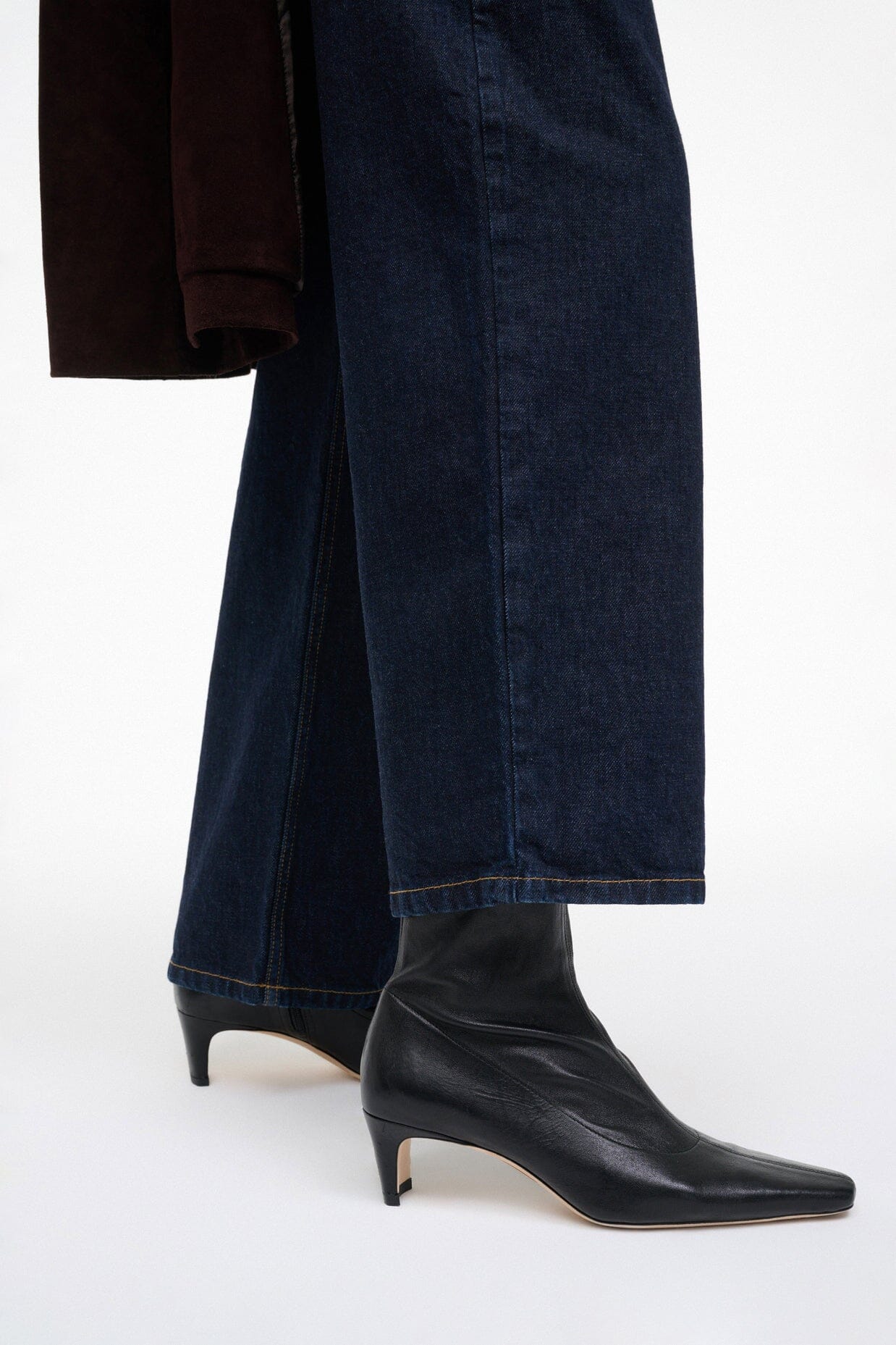 Black ankle sock boot with pointed toe and slim mid-height block heel.