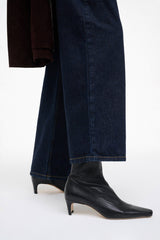 Black ankle sock boot with pointed toe and slim mid-height block heel.