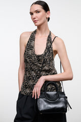 Black mini carryall handbag with rounded silhouette, textured panel, zipper-top closure