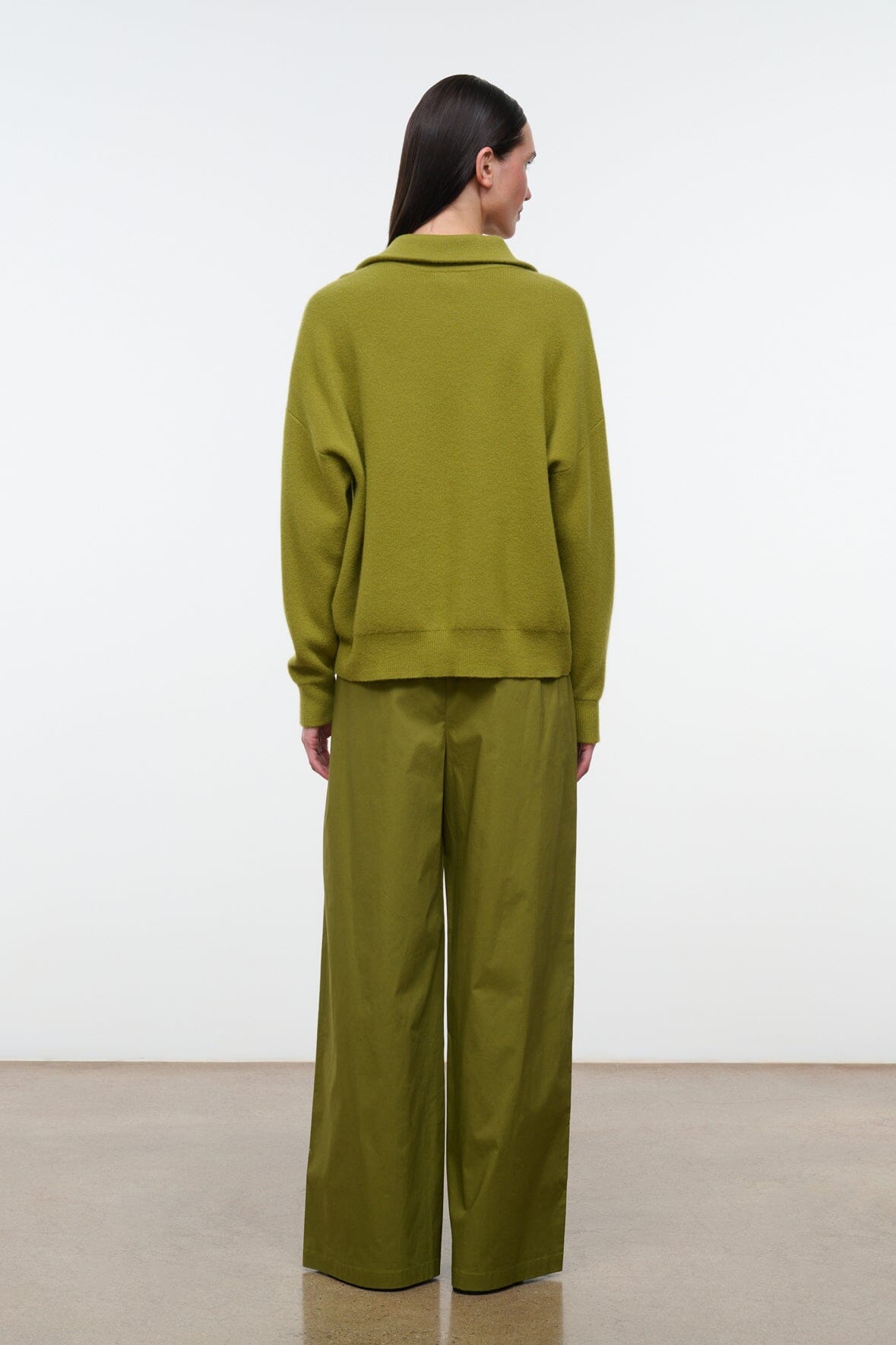 Mateo pants in pear green, back view with elastic waist and wide legs