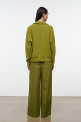 Mateo pants in pear green, back view with elastic waist and wide legs
