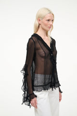 Black sheer ruffle V-neck button top with layered cuffs and tiered hem