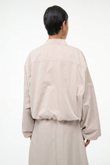 Fawn cropped zip-up jacket with stand collar and relaxed long sleeves