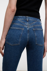 Stone blue denim jeans back yoke close-up with stitched back pockets