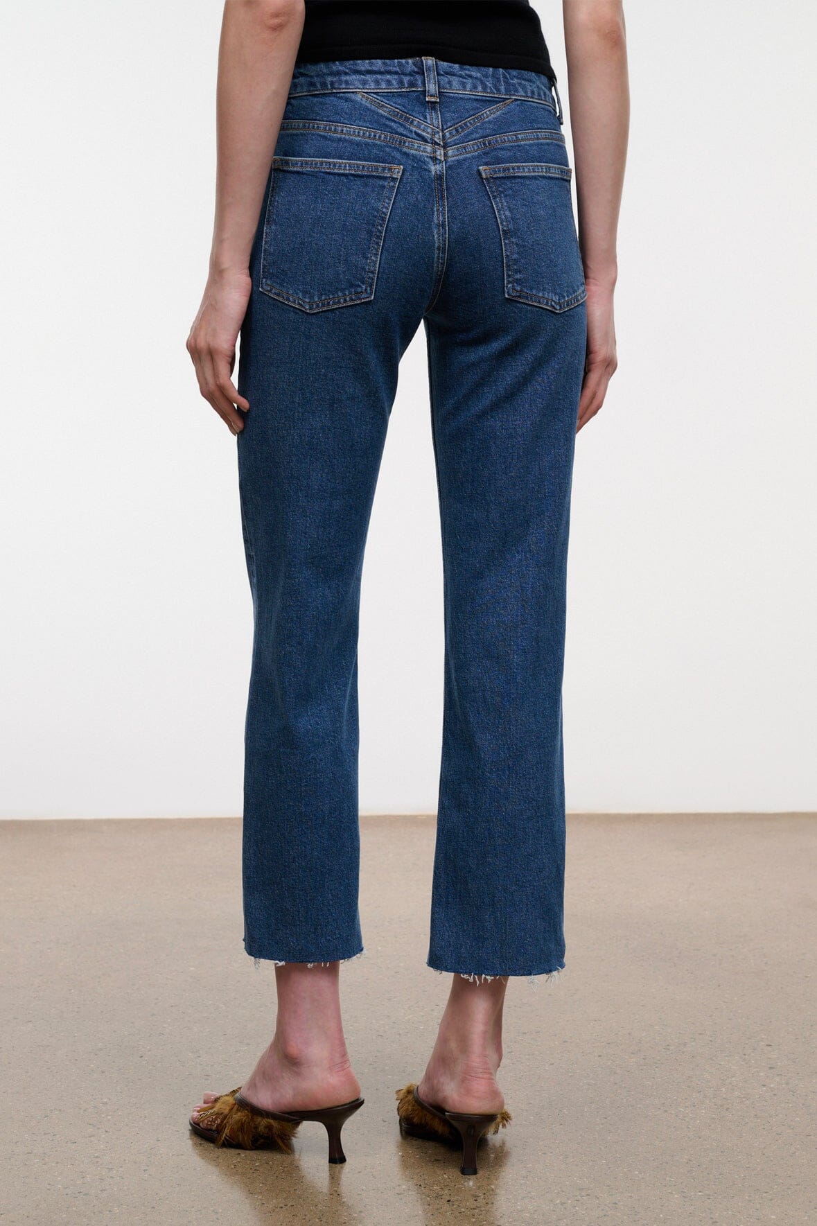 Stone blue denim cropped jeans with raw hem, front rise and straight legs