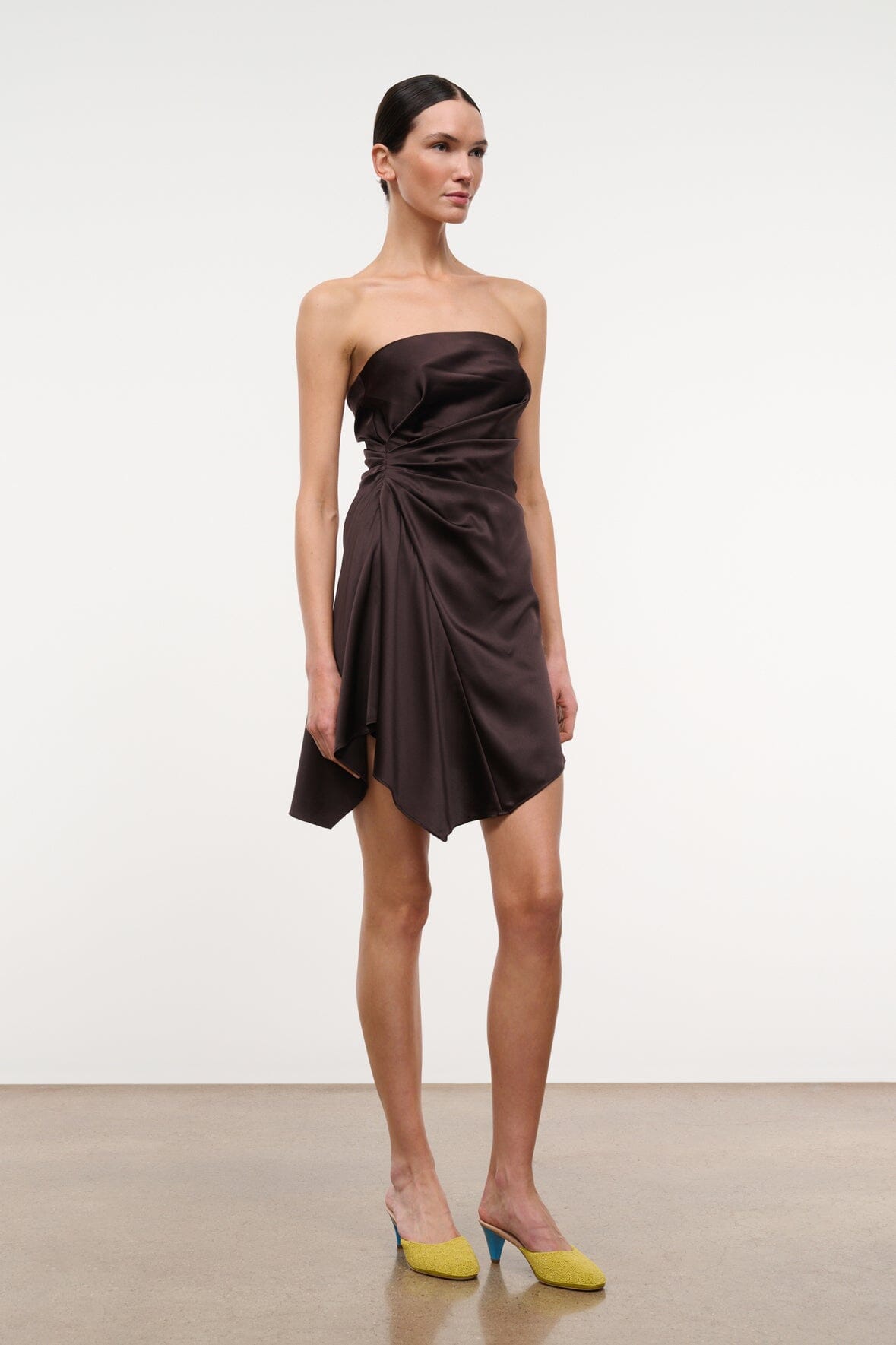 Strapless ruched satin mini dress in dark brown with draped crossover skirt