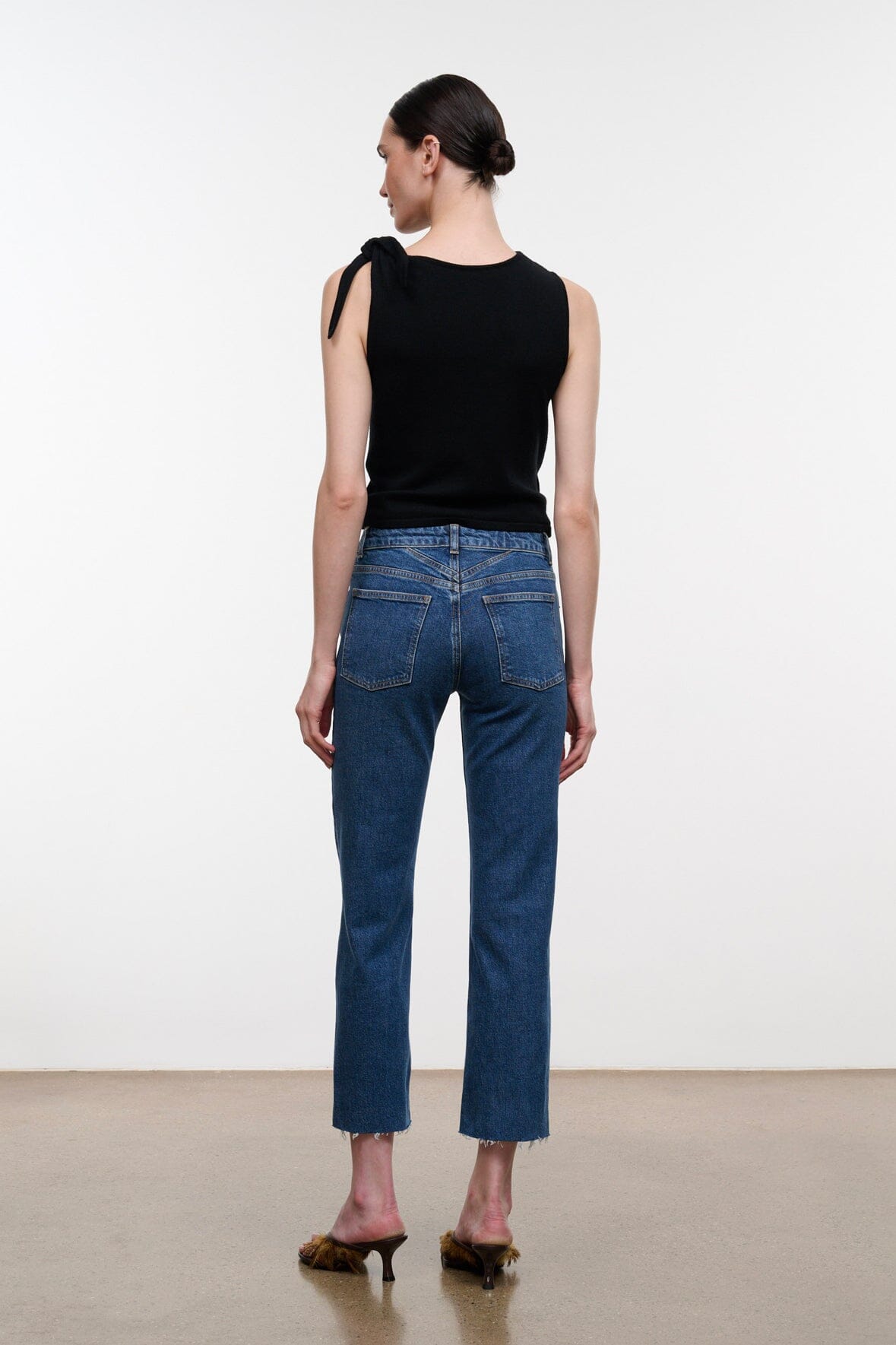 Stone blue denim cropped jeans with raw hem, back pockets and belt loops