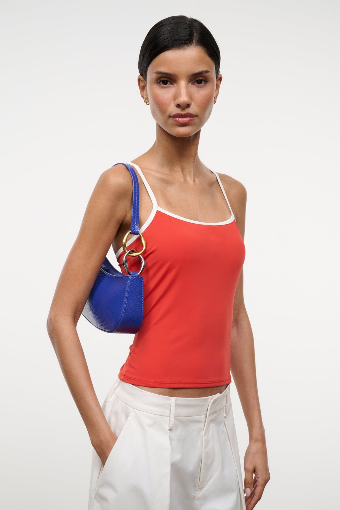 Cobalt blue hobo handbag carried on shoulder with gold ring hardware detail