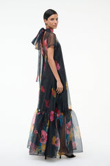 Black floral maxi dress, high neckline and short sleeves, side view of tiered skirt