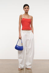 Cobalt blue hobo handbag held at side by top handle with gold ring hardware