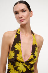 Floral halter dress with yellow daisies on black, pink-trimmed V neckline.