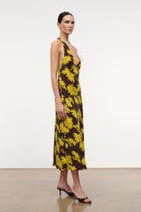 Sleeveless midi halter dress with yellow daisy print on dark background and deep V.