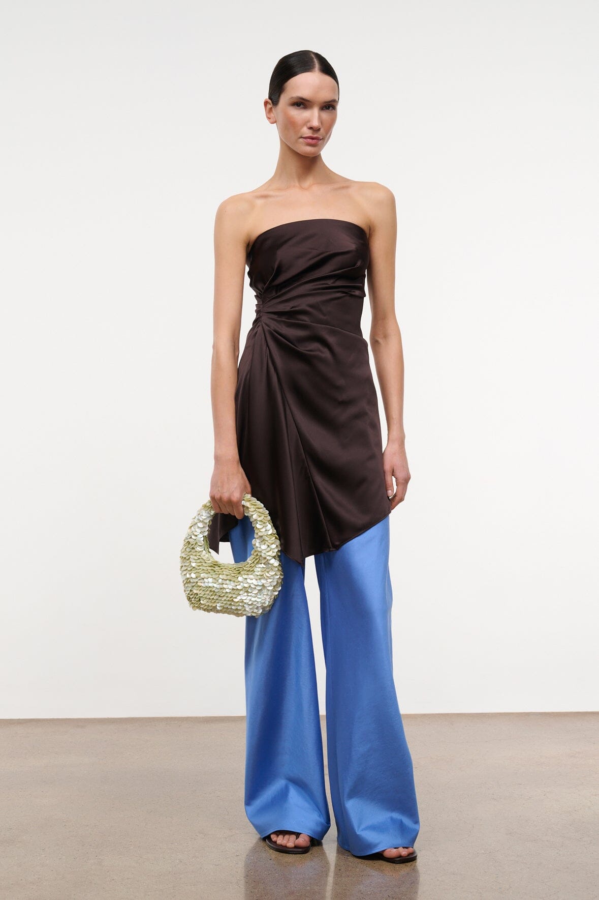 Light-green sequin-shell bag with short handle, carried at side