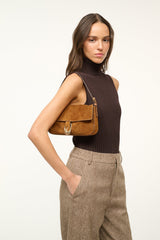 Tan suede Harlow bag with front flap and horseshoe clasp, shoulder strap
