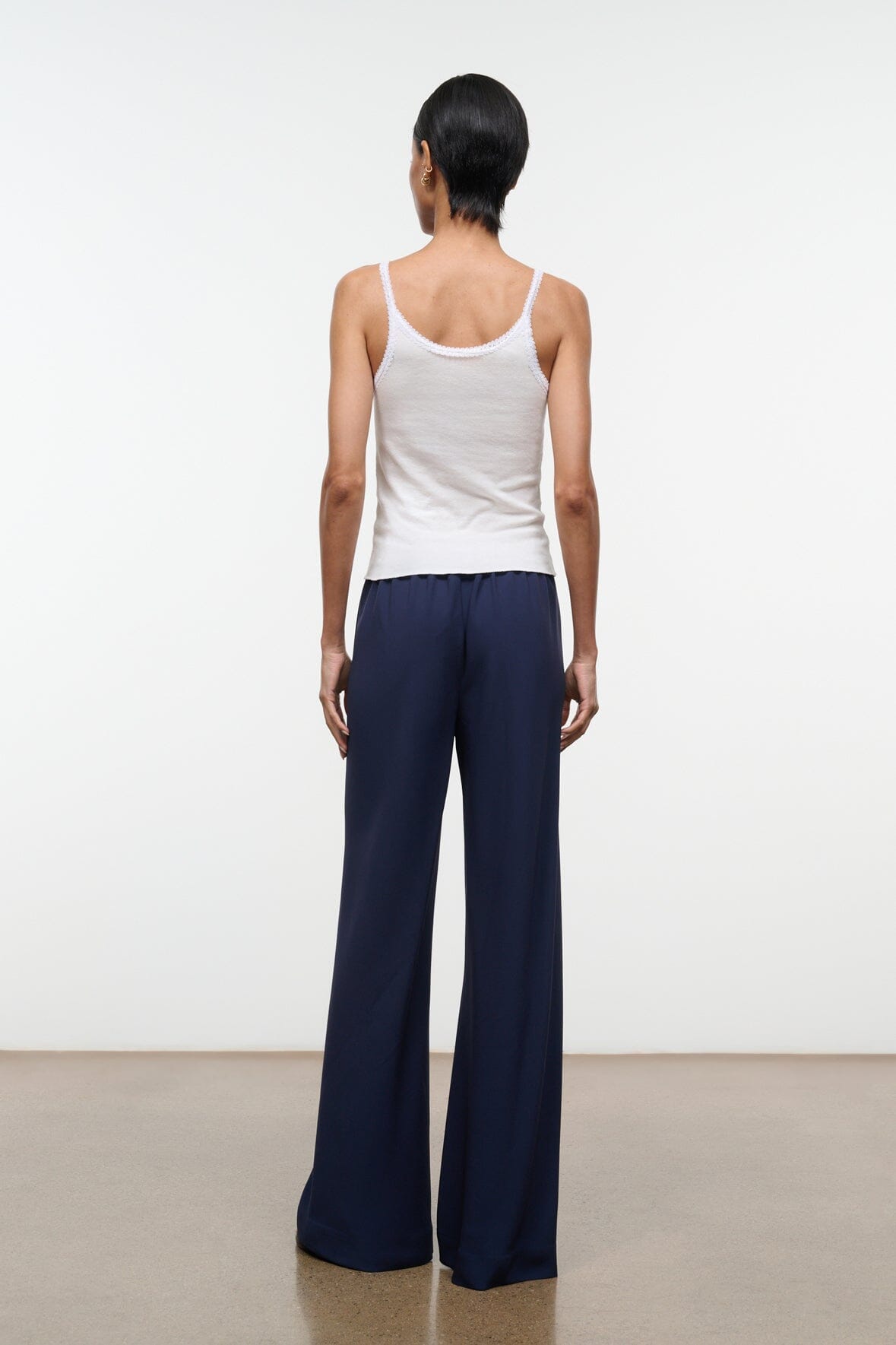 Navy wide-leg pants from back view with full-length straight legs
