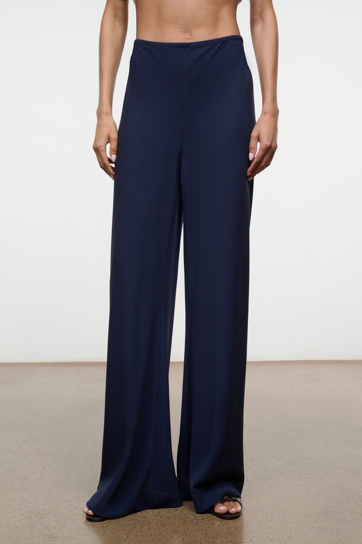 Navy wide-leg pants with elastic waist and draped, floor-length fit