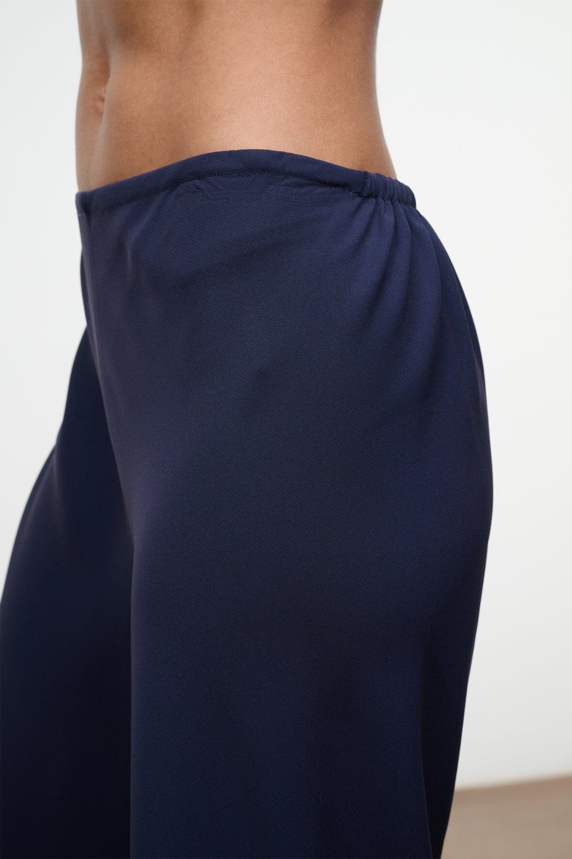 Navy elastic-waist waistband with gathered fabric at the back