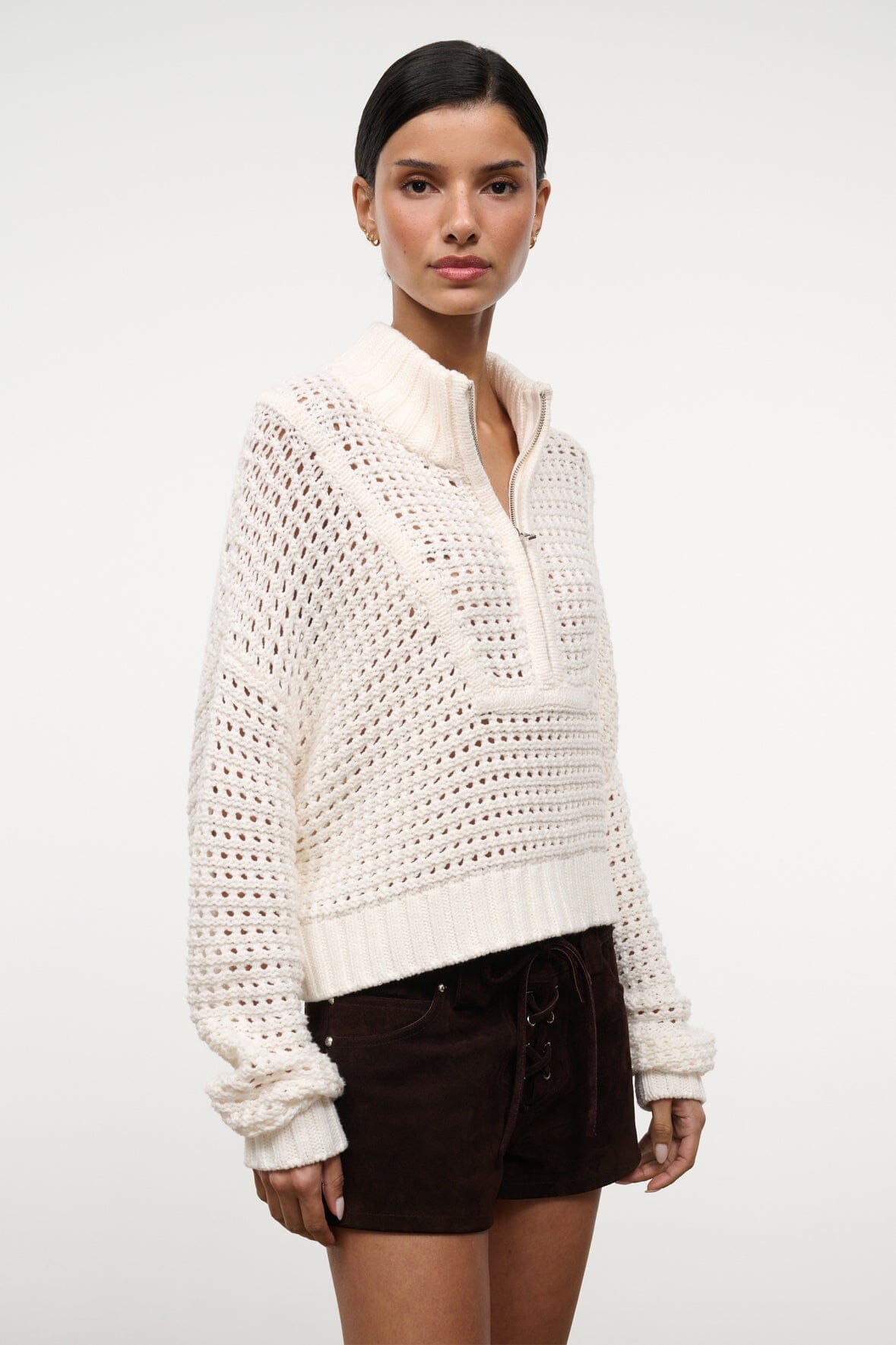 Cropped Hampton sweater in ivory knit with zip-front collar and textured pattern.