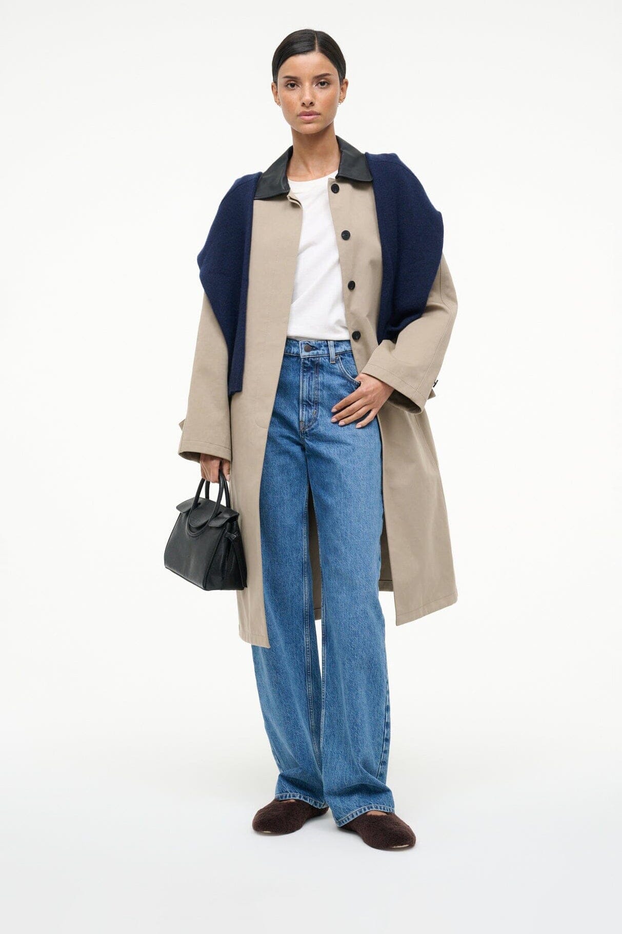 Woman wearing espresso shearling ballet flats with casual jeans and coat
