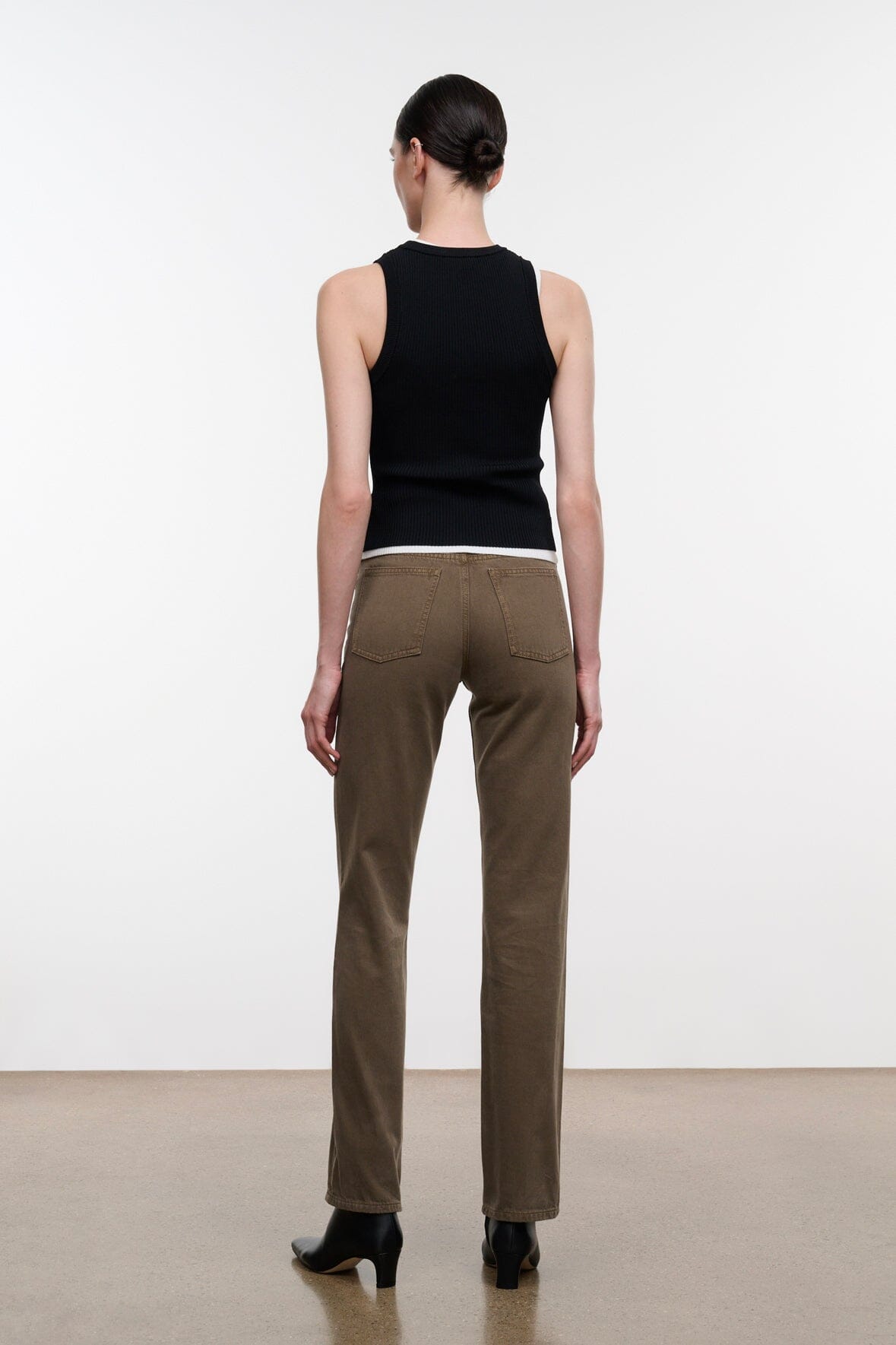 Greige straight-leg jeans from behind with belt loops and back seam detail