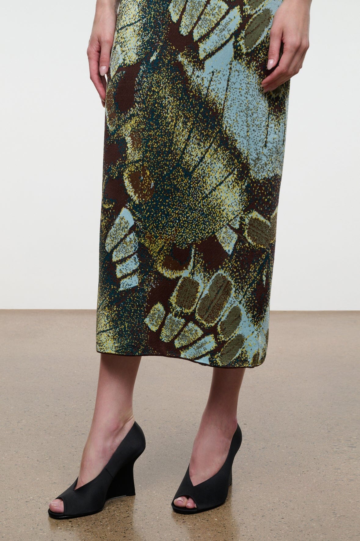 Black satin peep-toe wedge heels, open toe, shown on model