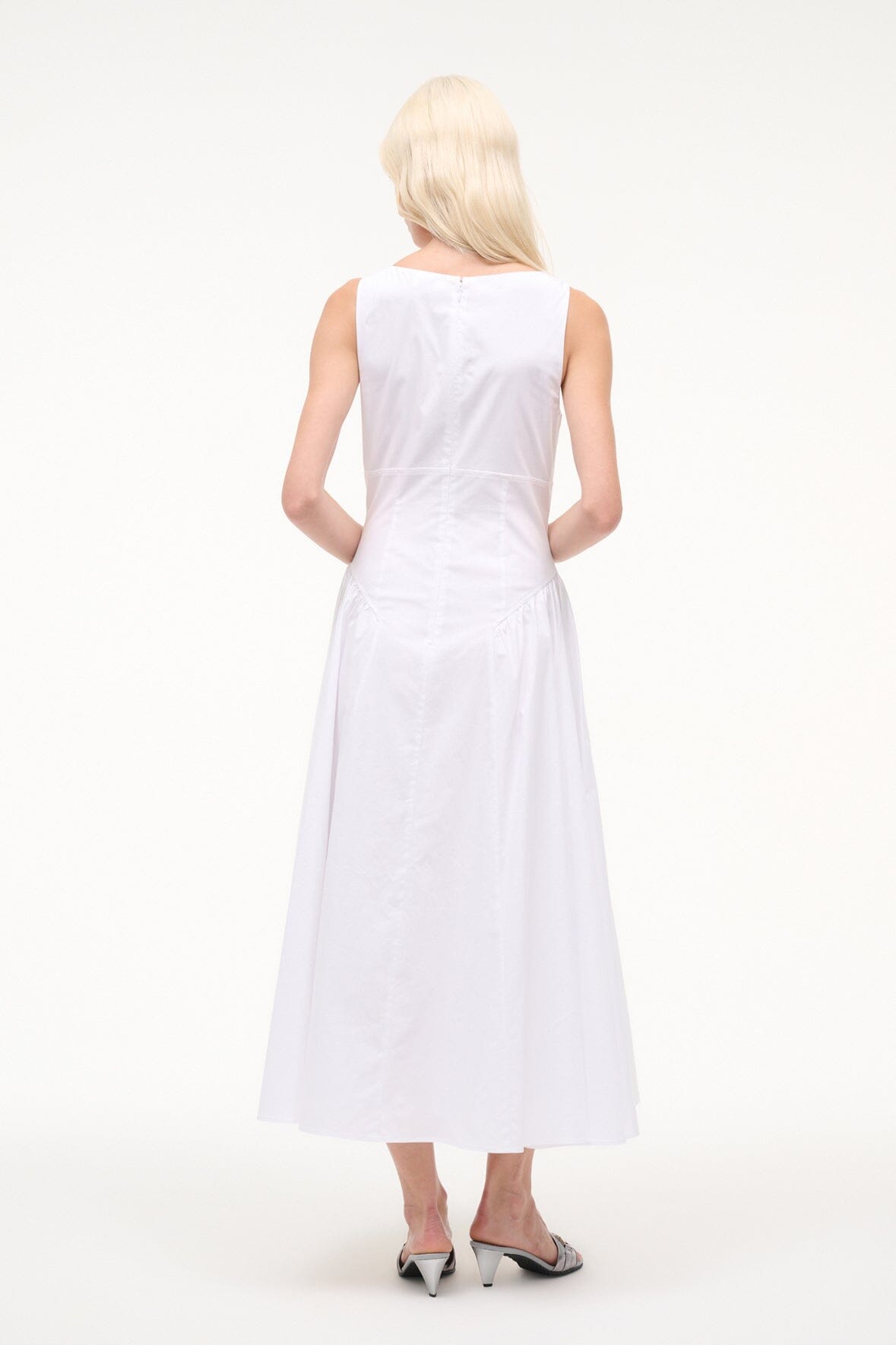 White sleeveless midi dress with V-back and gathered flare, rear view
