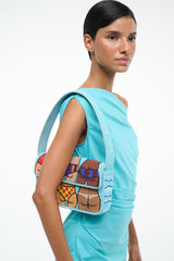 TOMMY beaded beach bag worn crossbody, turquoise with colorful rectangle bead design