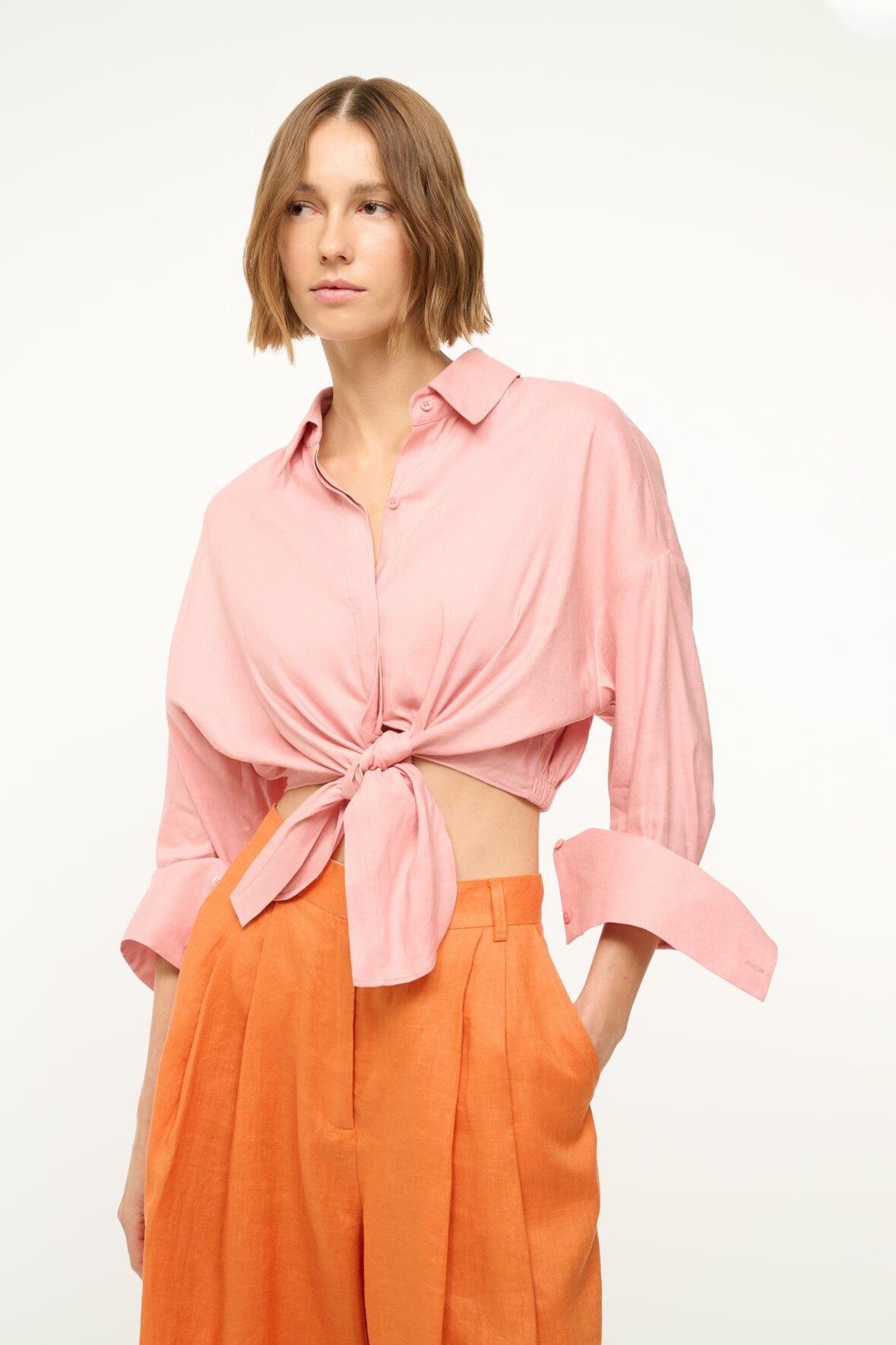 Faded blush linen button-up top with front knot detail and wide rolled sleeves