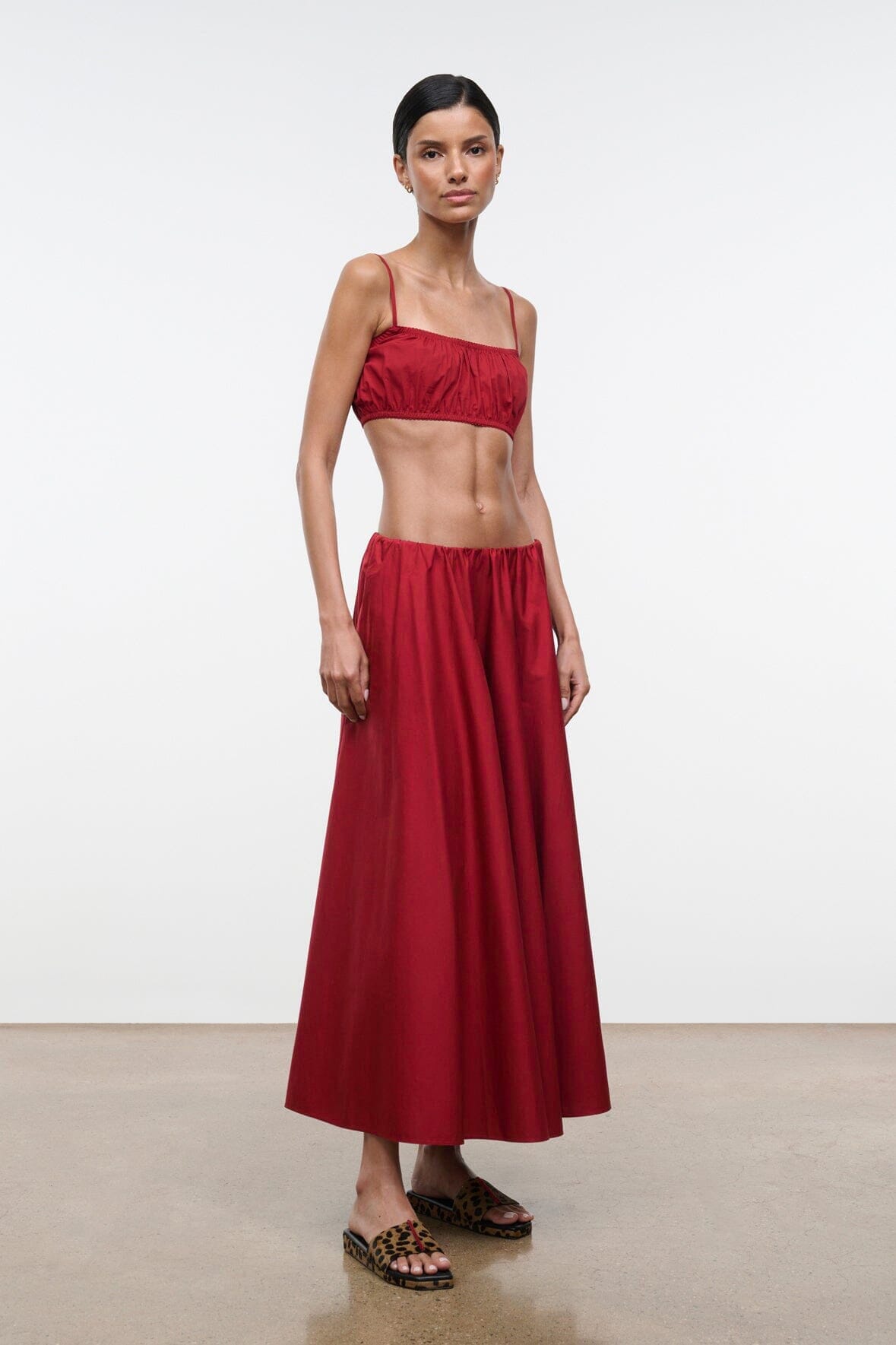 Red midi skirt with ruched, gathered waistband and flared pleated hem