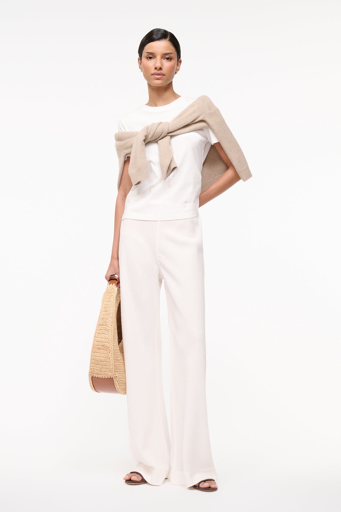 Ivory wide-leg trousers with a loose silhouette and long, flowing legs.