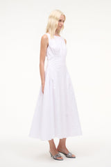 White sleeveless midi dress, fitted waist and flared skirt, side view